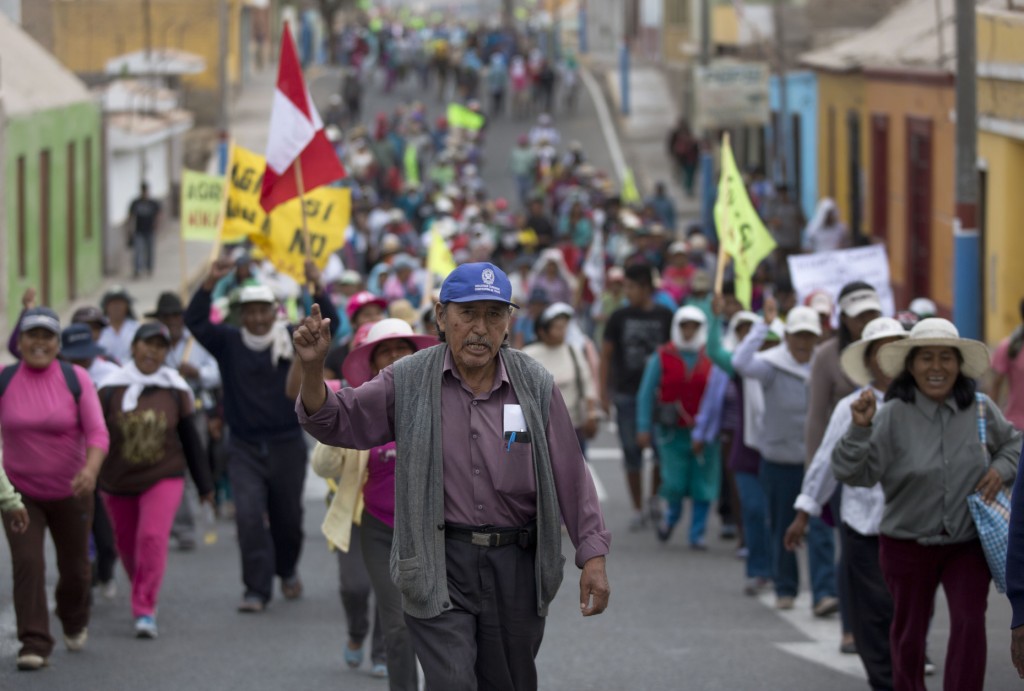 Farmers opposed to a mining project march in Cocachacra, Peru, Friday, May 15, 2015. Farmers and local leaders fear the $1.3 billion Tia Maria open-pit mine will contaminate irrigation water in the rice farming-rich Tambo valley on Peru's desert coast. Thousands have mobilized against the project, which is owned by Southern Peru Copper Corp., a subsidiary of Grupo Mexico. (AP Photo/Martin Mejia)